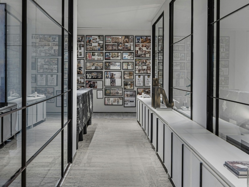 Stylish hallway with framed glass room separator and gallery wall display